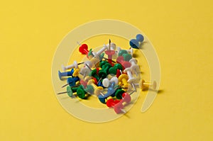 Stationery buttons of different colors on a yellow background