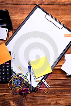 Stationery and calculator on wooden background. Office supplies concept.