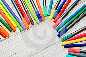 Stationery, colored felt-tip pens on a white table.