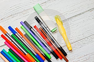 Stationery, colored felt-tip pens on a white table.