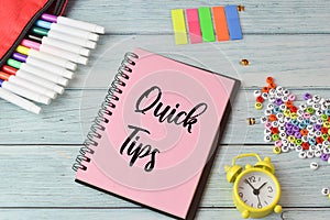 Stationery items and notebook written with QUICK TIPS