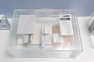 Stationery items in transparent acrylic glass organizer with drawers