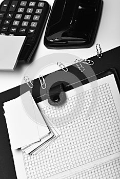 Stationery and leather covered notebook with blank pages. Business and work concept: office tools on black and white