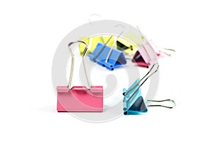 Stationery metallic colored binder clips. Close up. Isolated on