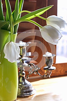 Stationery, a notebook, an extinct candle in a candlestick, and