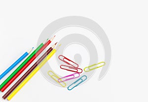 Stationery office supplies, Colored pencils with colorful clips on white background