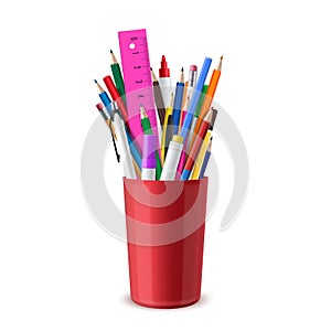 Stationery are in red plastic cup. Pens, pencils, eraser, felt-tips, markers, ruler. School or office supplies.