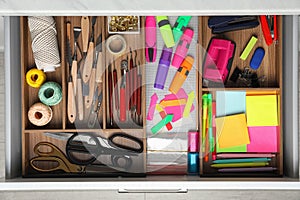 Stationery and sewing accessories in desk drawer