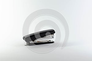 Stationery for stapling sheets of paper with metal staples. Isolated image of a stapler.