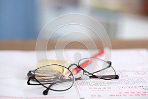 Stationery such as glasses and pencils on the test answer sheet