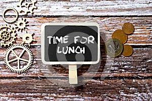 Stationery, tasty food in lunchbox and notebook with text TIME TO LUNCH on grunge blue background