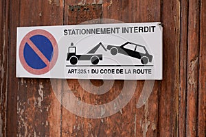 Stationnement interdit code de la route french text means risk car impound Traffic Laws front of personal home entrance door photo