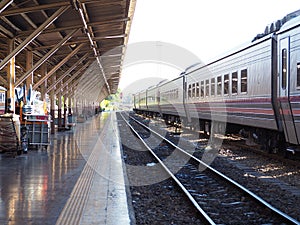 Stations and train tracks are gray, black, red, orange and gray-white sky and white light.