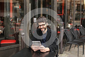 Statistician working tablet at cafe table .