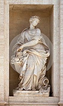 Statue of Abundance of Fruits. Detail of the Trevi fountain, Rome, Italy