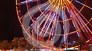 Statue of Ali and Nino on a background Ferris wheel at night on the embankment of Batumi, Georgia