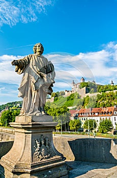 Statue on the Alte Mainbrucke and Marienberg Fortress in Wurzburg, Germany