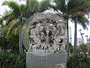 Statue amid palm trees outside University of Tampa