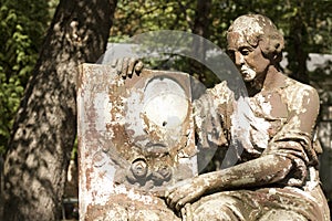Statue of ancient angel on cemetery