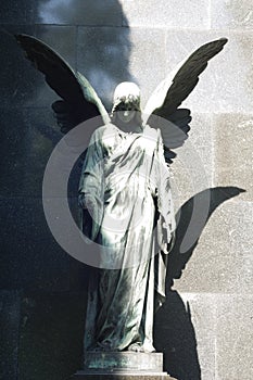 Statue of ancient angel on cemetery