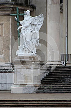 statue of an angel in front of a baroque church (karlskirche) in vienna (austria)