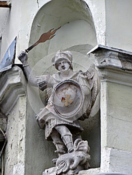 Statue of the angel Saint George with the flaming sword of the victorious dragon. Stone figure