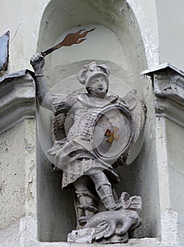 Statue of the angel Saint George with wings behind his back and the flaming sword of the victorious dragon