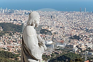 Statue of apostle observing on city Barcelona on Temple Sacred Heart of Jesus on Mount Tibidabo