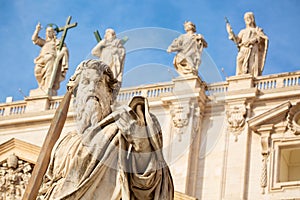 Statue of Apostle Paul with a sword in front of the St Peter`s Basilica, Rome, Italy during summer sunny day. Facade exterior in