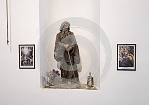 Statue of bearded man with walking stick in a small church at Masseria Il Frantoio, Southern Italy