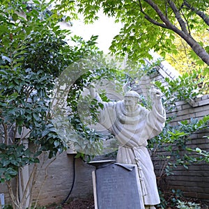 Statue of Benedictine Monk with Tonsure in Small Courtyard