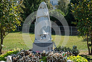 Statue of Bernadette of Lourdes with flowers