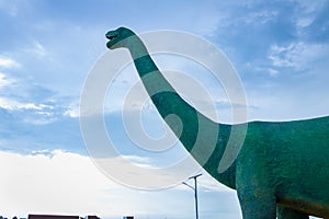 Statue big dinosaur in the park with blue sky at khon kaen, Thailand. photo