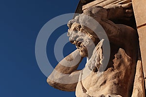 Statue of blacksmith Juraj Corgon, as Atlant supporting corner of bishop palace in Nitra, Slovakia.