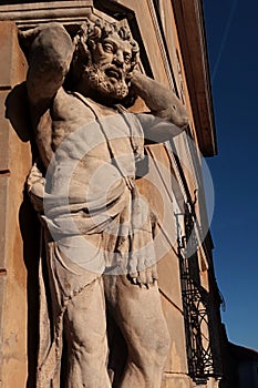 Statue of blacksmith Juraj Corgon, as Atlant supporting corner of bishop palace in Nitra, Slovakia.