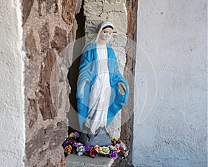 Statue of the Blessed Virgin Mary with her feet surrounded by roses in Marfa, Texas.