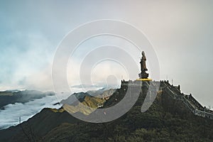 Statue of the Bodhisattva on Fansipan mountain peak the highest mountain in Indochina Backdrop Beautiful view blue sky and cloud