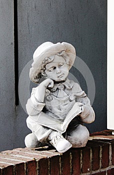 Statue of a boy in front of a home in Volendam photo