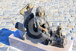 Statue of boy and girl near little puppy