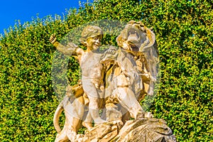 Statue of a boy and a lion at la Promenade du Peyrou in Montpellier, France