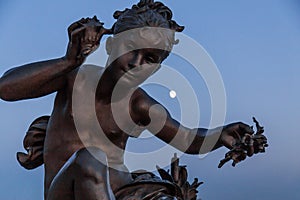 Statue of a boy at point Alexander III bridge in Paris France