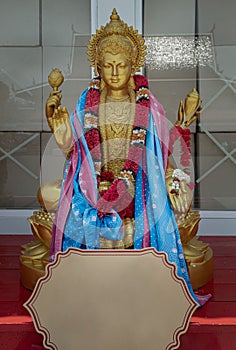 Statue of Brass Hindu goddess lakshmi sculpture (Maha laxshmi) decorated with Flowers Garland