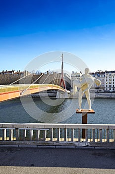 Statue and bridge along the Saone river at Lyon city, France