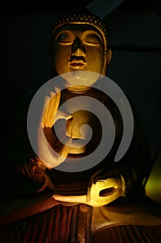 Statue of Buddah in low light photo