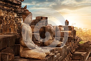 Statue of Buddha against the background of the sunrise in the temple of Borobudur. Java island. Indonesia.