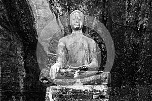 Statue of Buddha in the middle of temple in the mountain. Picture was shot in black and white.