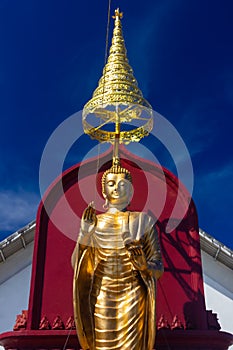 Statue of the Buddha stood beautifully sky background at Thailand