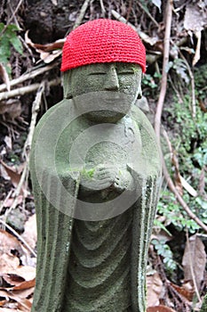 statue of buddhist (?) divinity (jizo ?) in a forest at the tachikue gorge (japan)