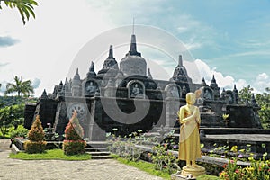 Statue of the Buddhist God Buddha in the Buddhist temple Brahma Vihara Arama with statues of the gods on Bali island, Indonesia.