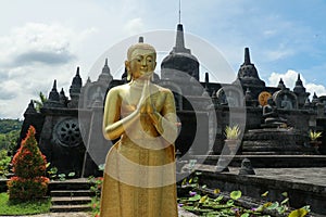 Statue of the Buddhist God Buddha in the Buddhist temple Brahma Vihara Arama with statues of the gods on Bali island, Indonesia.